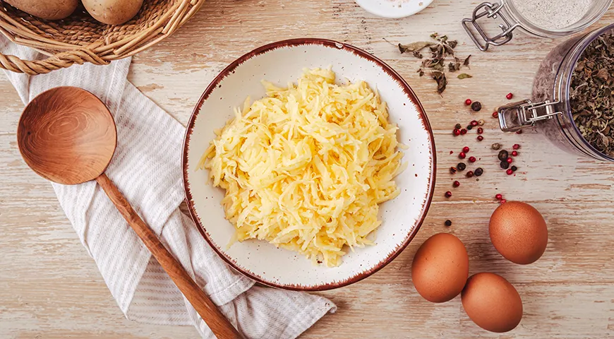 Классические драники — это поджаристые оладьи, для которых используют сырой тертый картофель, немного репчатого лука, яйцо и муку