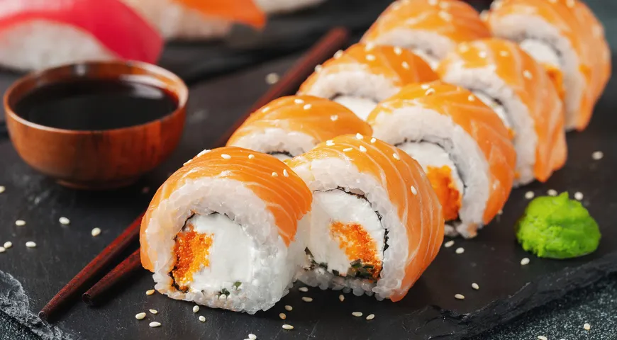 Ролл Филадельфия часто дополняют тобико (икрой летучей рыбы) и кунжутом